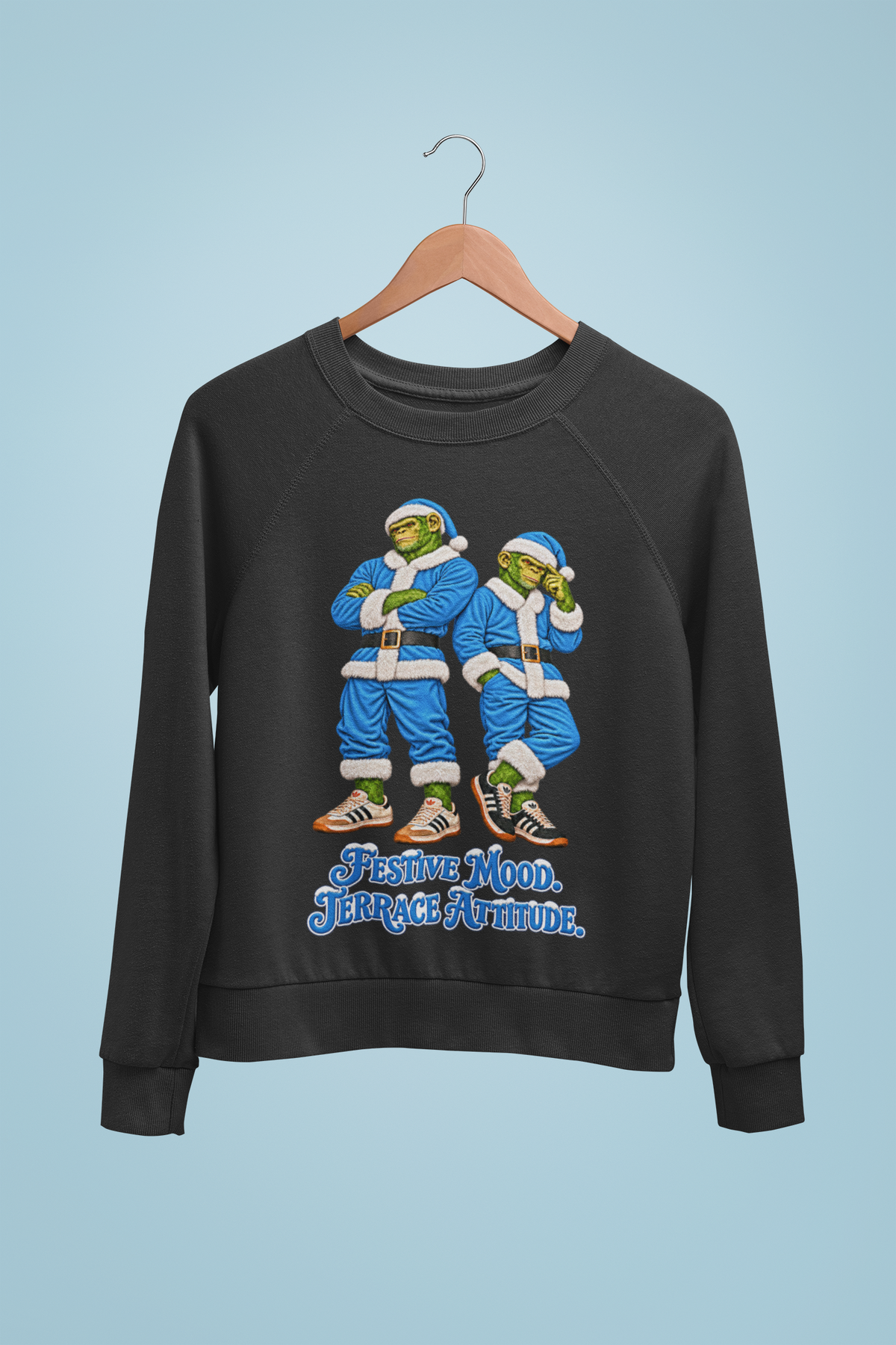 Sky blue Santa chimps Christmas sweatshirt on a hanger against a sky blue wall, Man City and Coventry colours