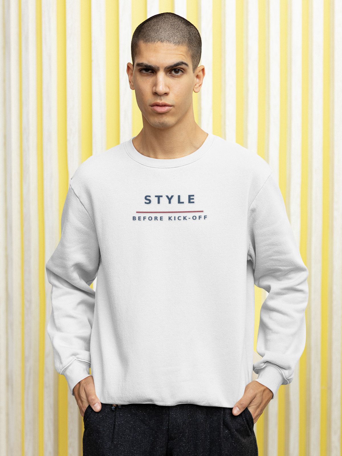 Man wearing the white Style Before Kick-Off football casuals sweatshirt against a striped wall