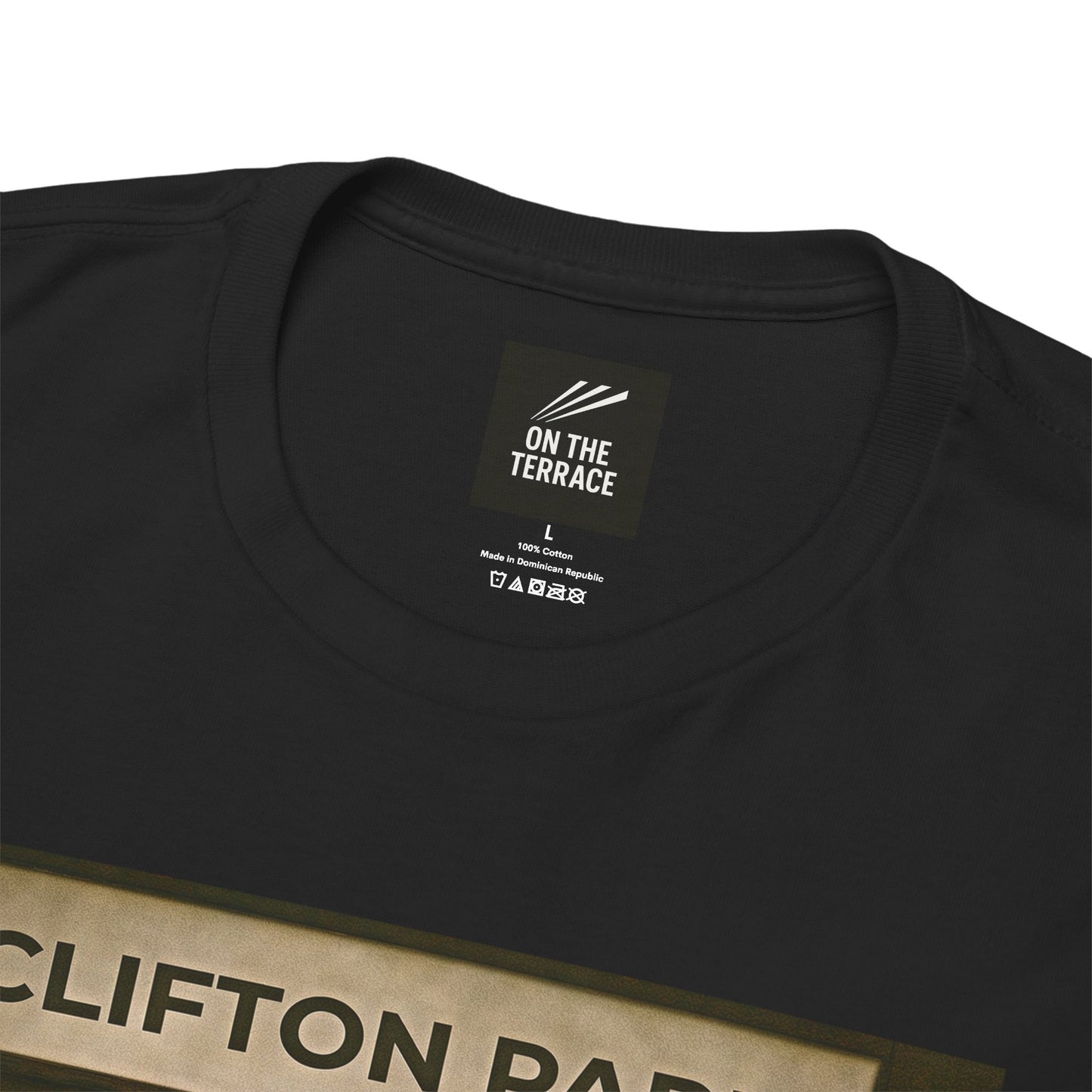 Close-up of a black crewneck Reytons t-shirt showing the inner neck label with 'ON THE TERRACE' branding and part of a beige graphic print at the bottom.