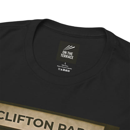 Close-up of a black crewneck Reytons t-shirt showing the inner neck label with 'ON THE TERRACE' branding and part of a beige graphic print at the bottom.