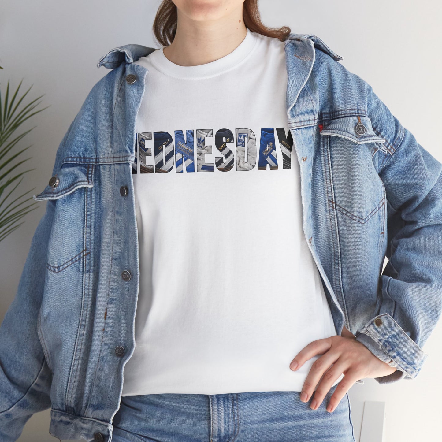 Person wearing the white SWFC WEDNESDAY tee with retro three-stripe trainer graphics