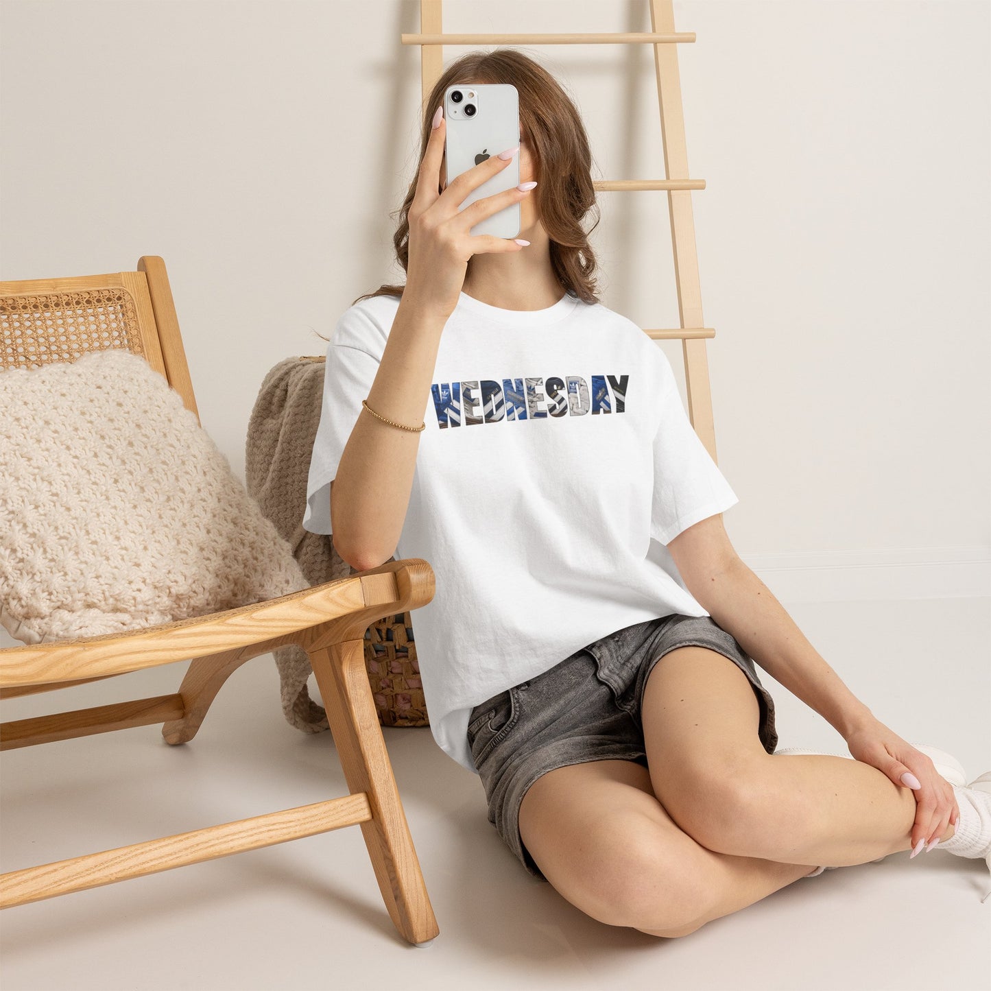 Woman taking a mirror selfie in the white Sheffield Wednesday WEDNESDAY tee