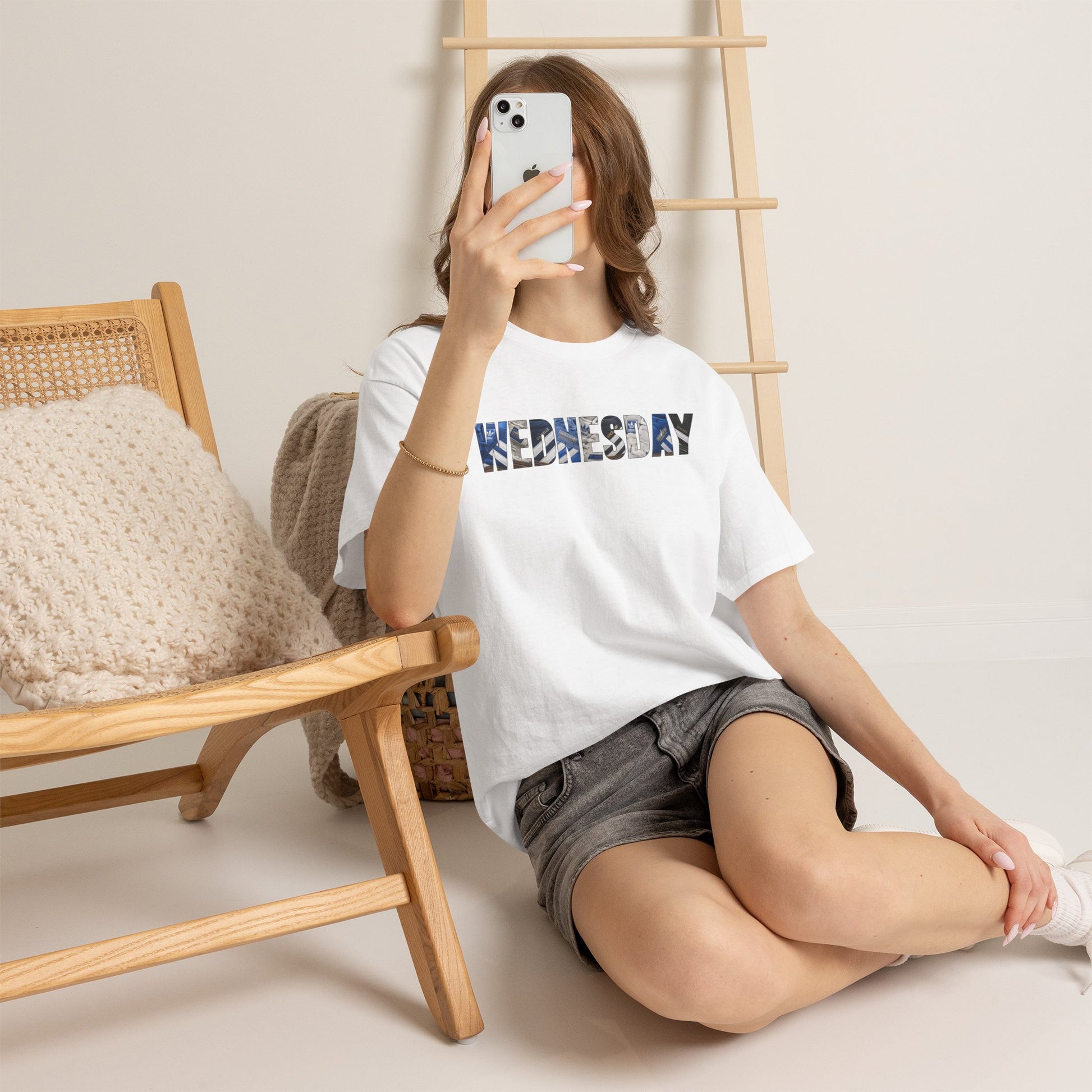 Woman taking a mirror selfie in the white Sheffield Wednesday WEDNESDAY tee