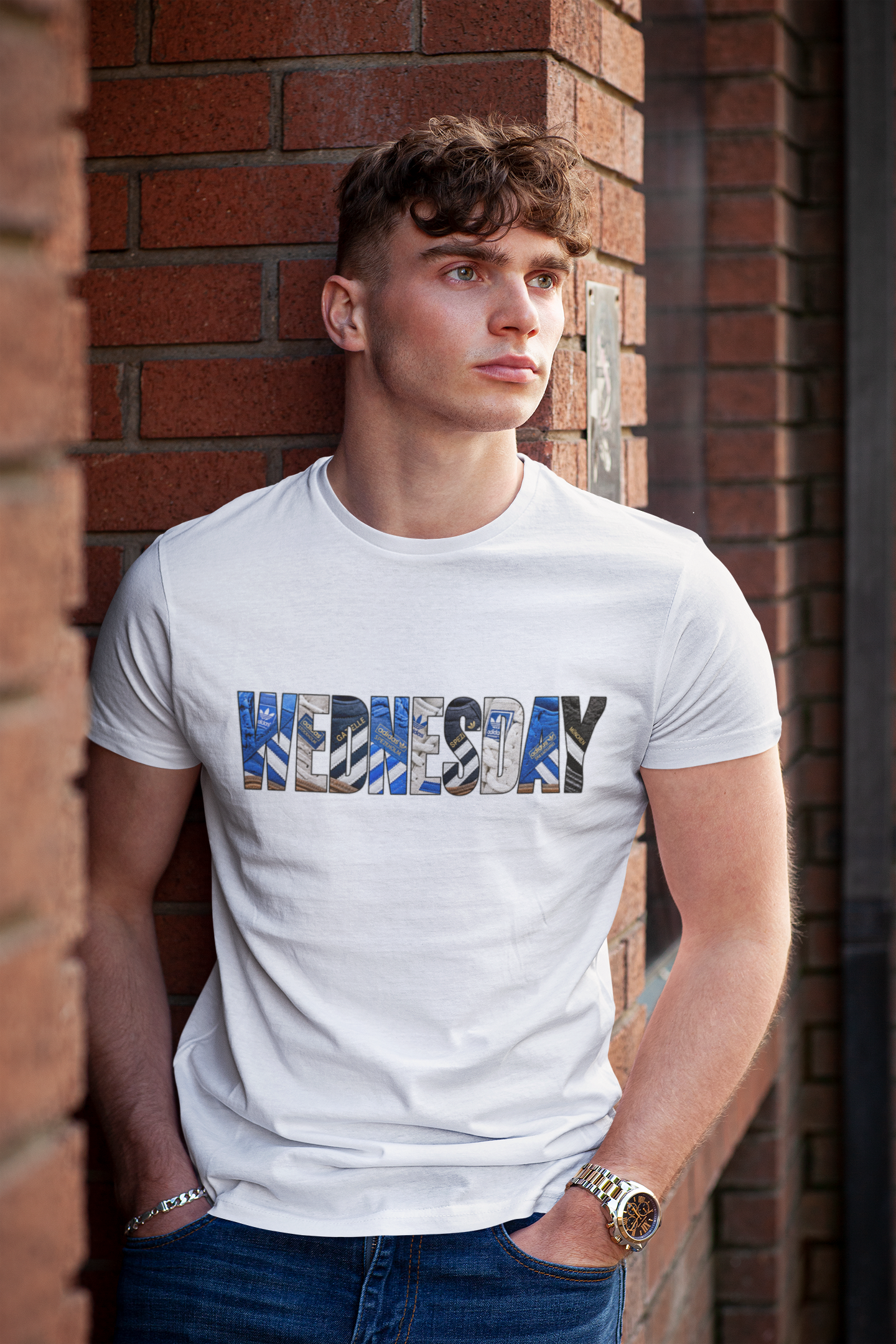 Young man wearing the white SWFC tee with WEDNESDAY spelled in vintage trainers