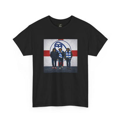 A black short-sleeve crewneck swfc t-shirt featuring a rectangular graphic print on the front. The graphic shows three men standing in front of a hockey-themed background with the number 88 and a red and white cross design.