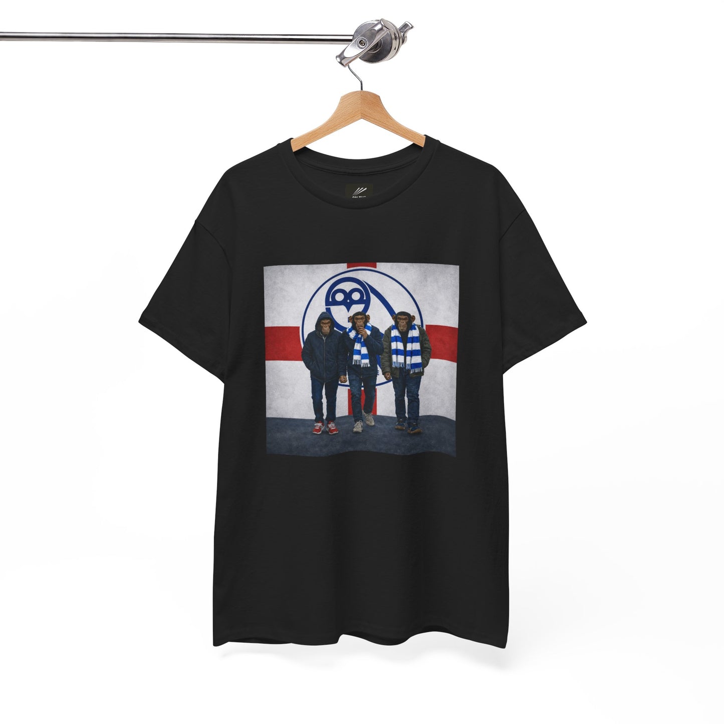 A black short-sleeve swfc t-shirt hanging on a wooden hanger from a metal rack, featuring a graphic print of the band Death Cab for Cutlass on a white, red, and blue background.