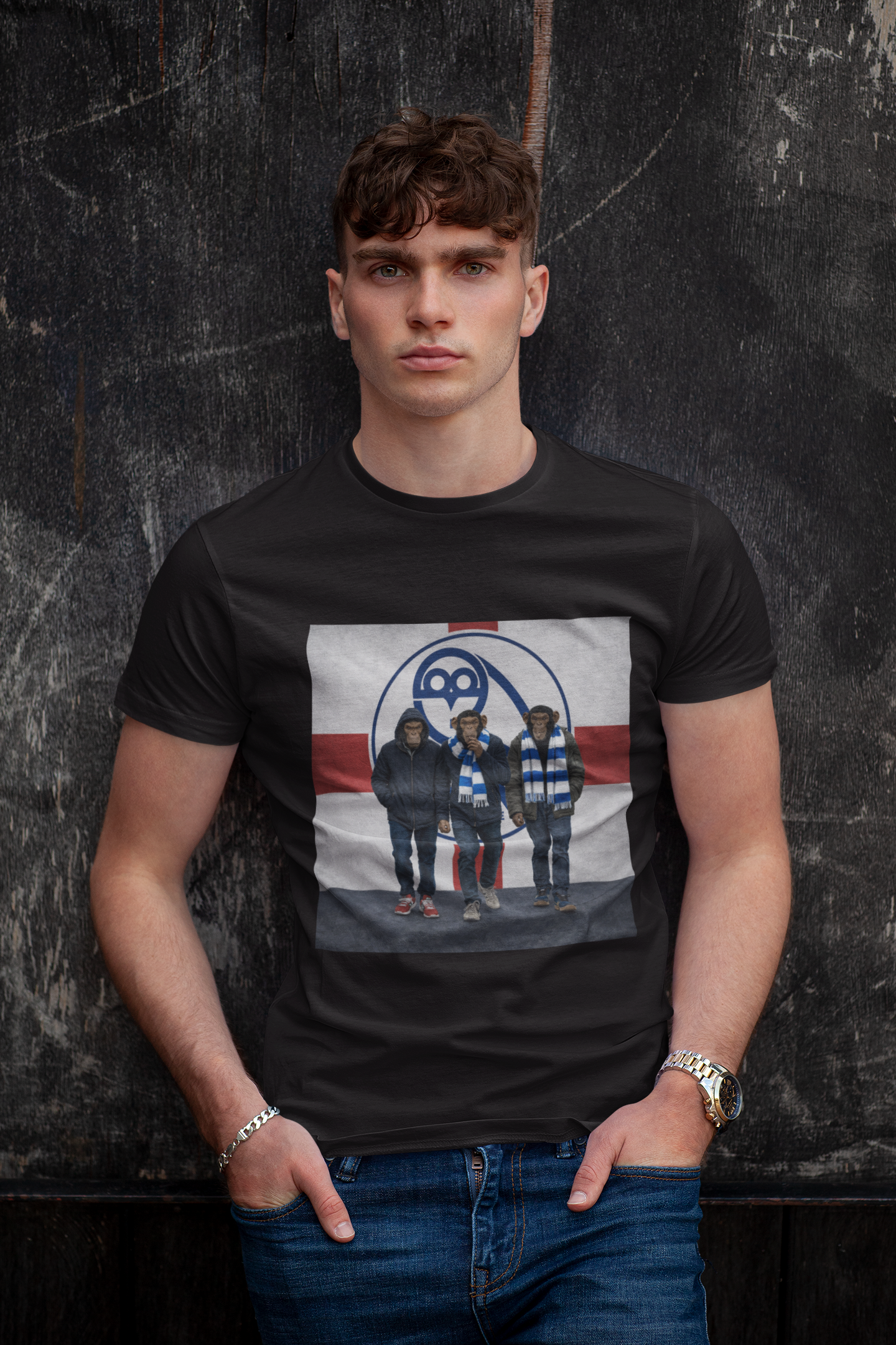 A man wearing a black swfc t-shirt with a graphic print of the band Soundgarden, posed against a dark textured wall.