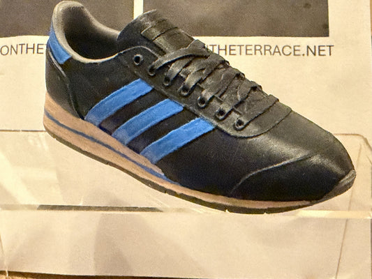 Angled view of black and blue Marathon SPZL NG Noel Gallagher inspired miniature trainer