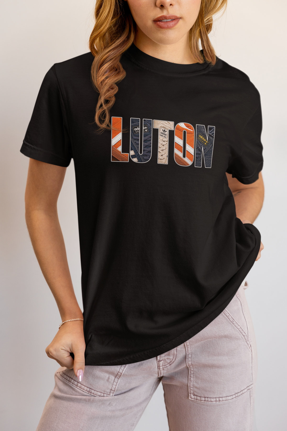 Woman wearing black Luton Town Vintage Trainers T-shirt