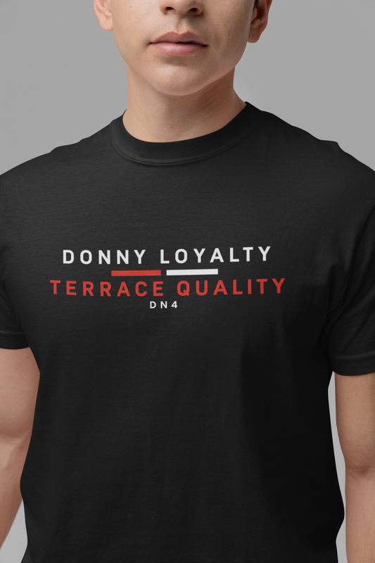 Man wearing black Donny Loyalty Terrace Quality T-shirt, close-up of white and red chest print