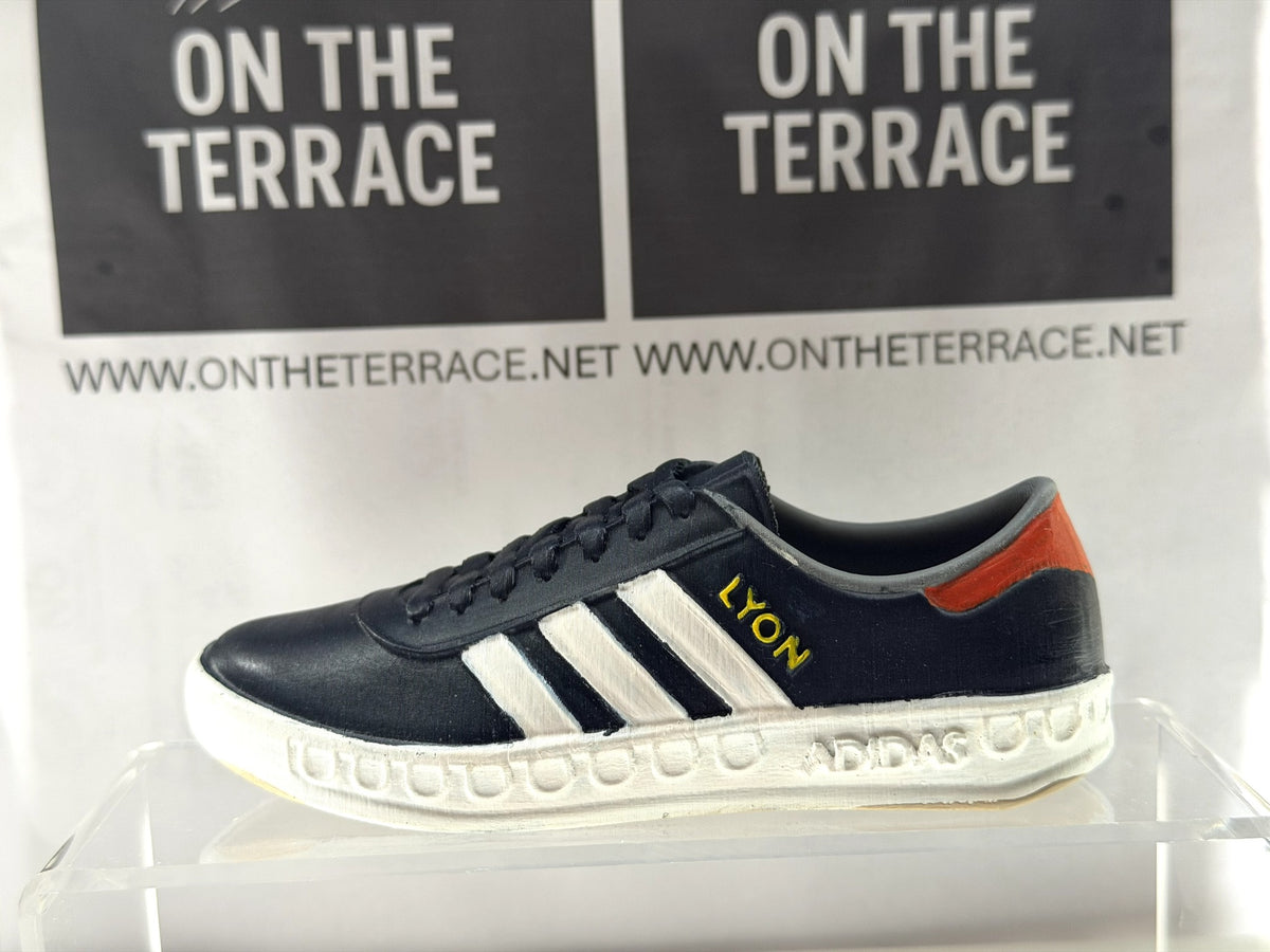 Painted 3D printed adidas Lyon inspired trainer model, 120mm, side view with dark upper, white stripes and yellow LYON lettering