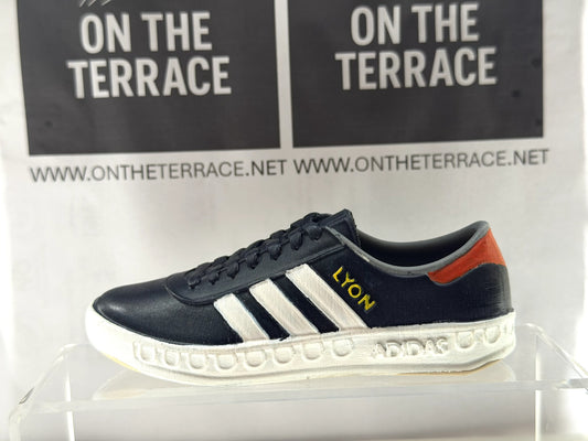 Painted 3D printed adidas Lyon inspired trainer model, 120mm, side view with dark upper, white stripes and yellow LYON lettering