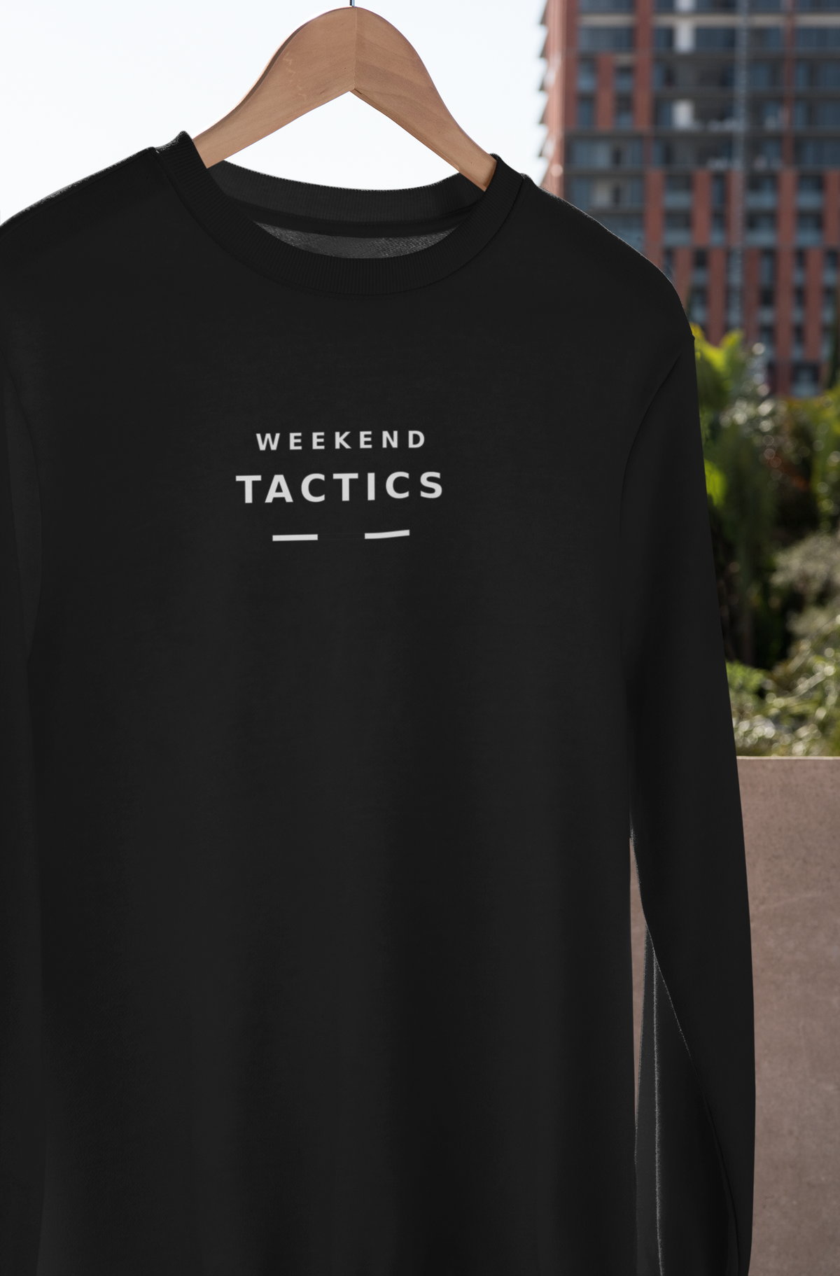 Black Weekend Tactics sweatshirt on a wooden hanger outdoors