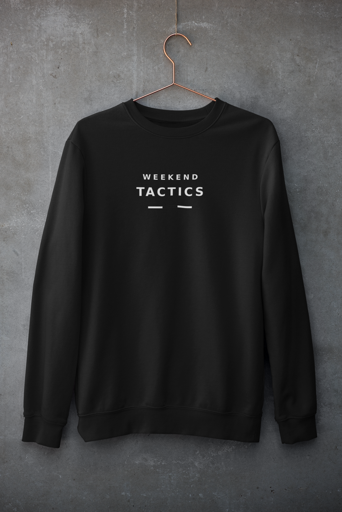 Black Weekend Tactics sweatshirt hanging against a concrete wall