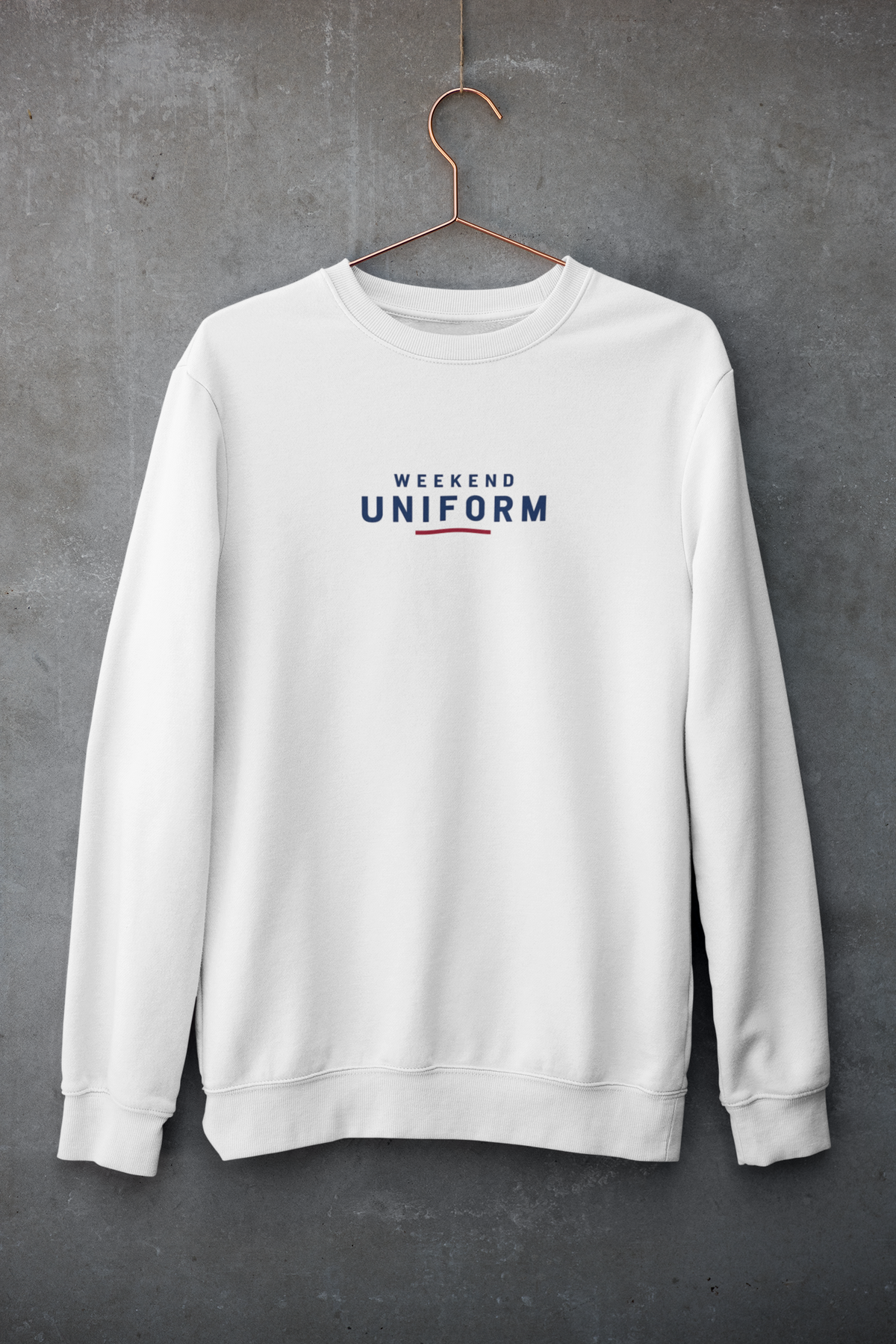 White Weekend Uniform embroidered sweatshirt on a hanger against a concrete wall