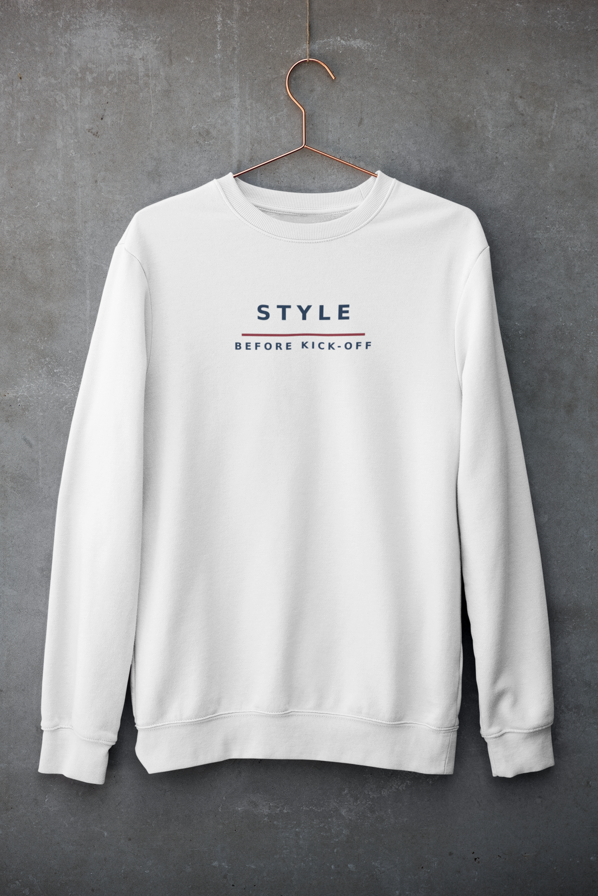 White Style Before Kick-Off sweatshirt on a hanger against a concrete wall