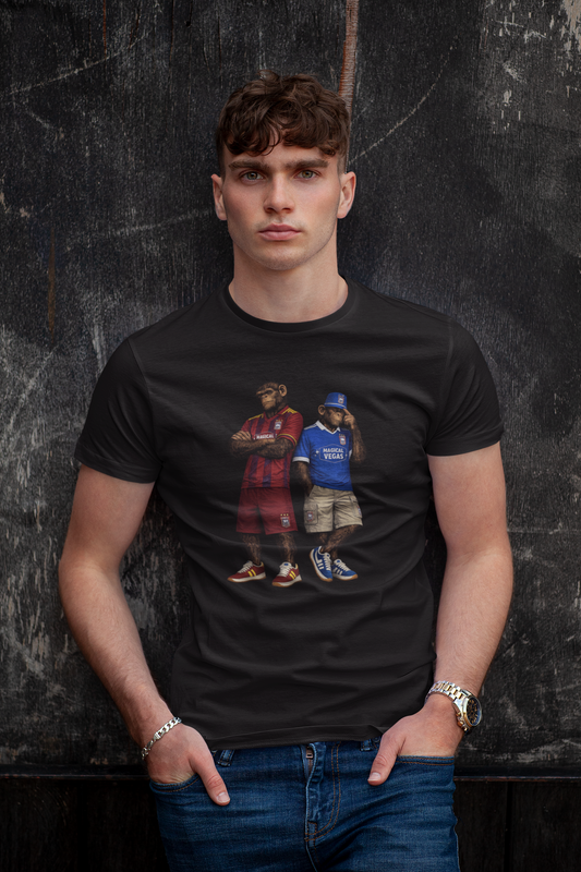 A man wearing a black Ipswich t-shirt with a graphic print of two men in streetwear, posed against a dark textured wall.