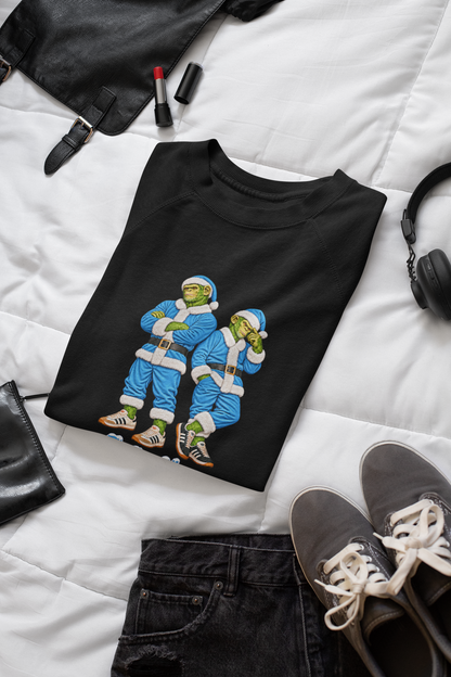 Folded black sky blue Northern Monkeys Christmas jumper flat lay with jeans, trainers and leather jacket